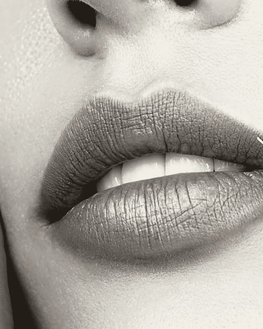 A close study of a mouth, lit from the side