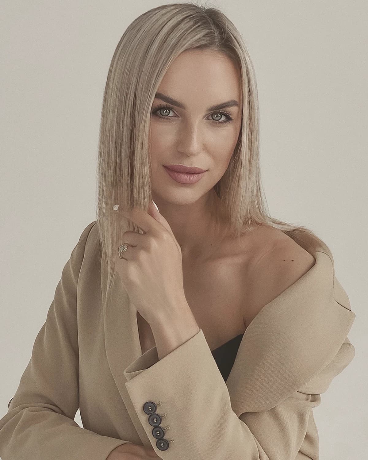 Vlada Bilenca, photographed in a camel blazer against a pale wall